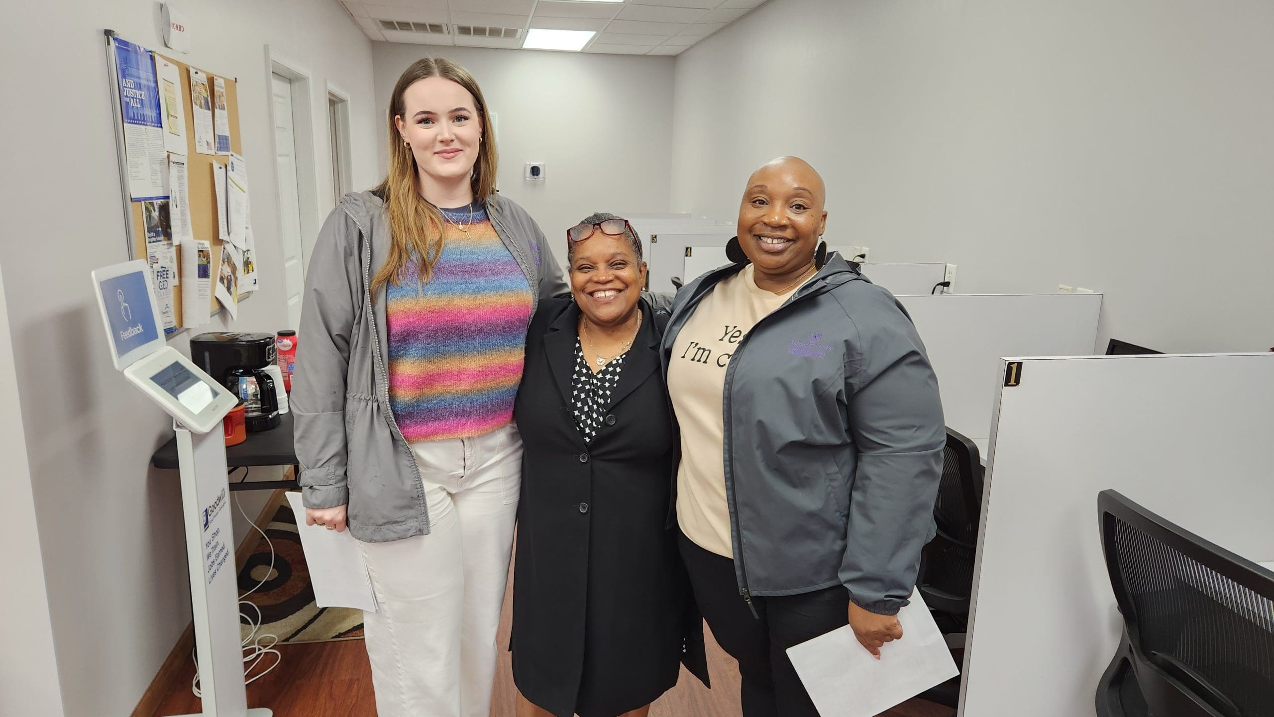 Left to right: Tanner Briggs, Outreach and Rapid Rehousing Advocate; Marie Champagne, Goodwill Career Services Specialist; and Tadren Harris, Victim Advocate at Magnolia House. The group is standing in Goodwill's Waycross Opportunity Center, co-located with the Goodwill retail store.