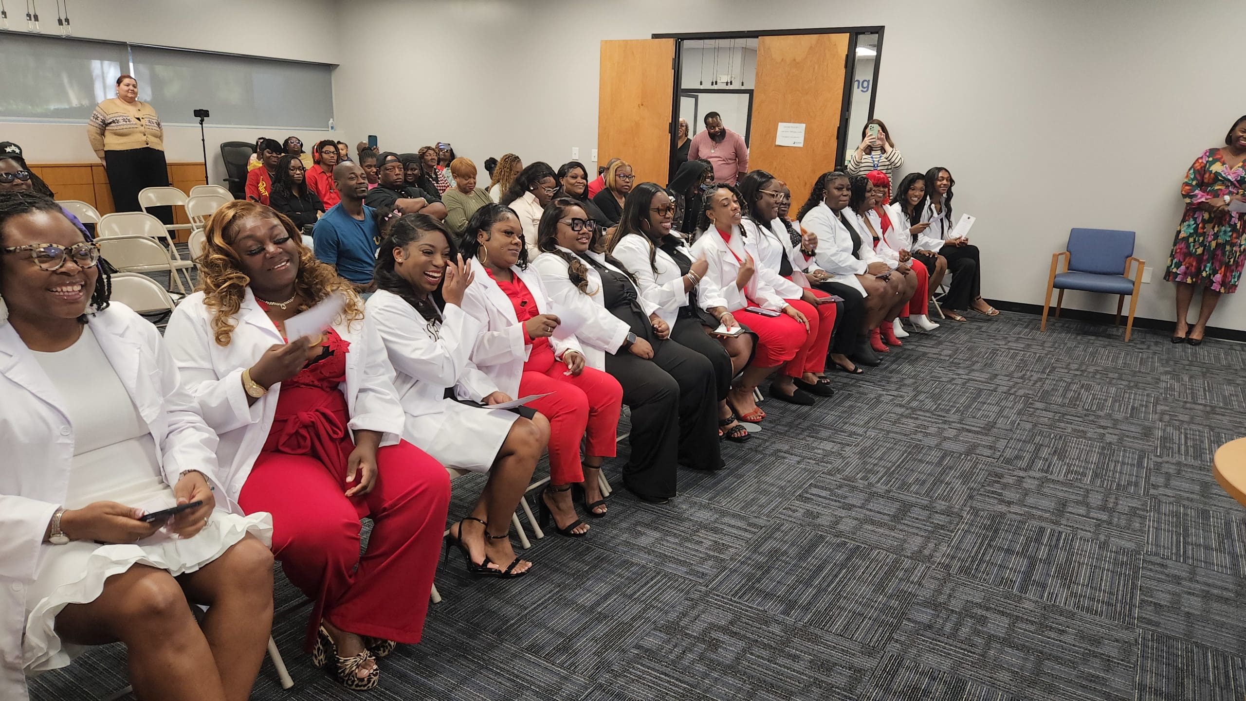 The Phlebotomy Technician Fall 2024 cohort laughs as their instructor recounts memories from the course.