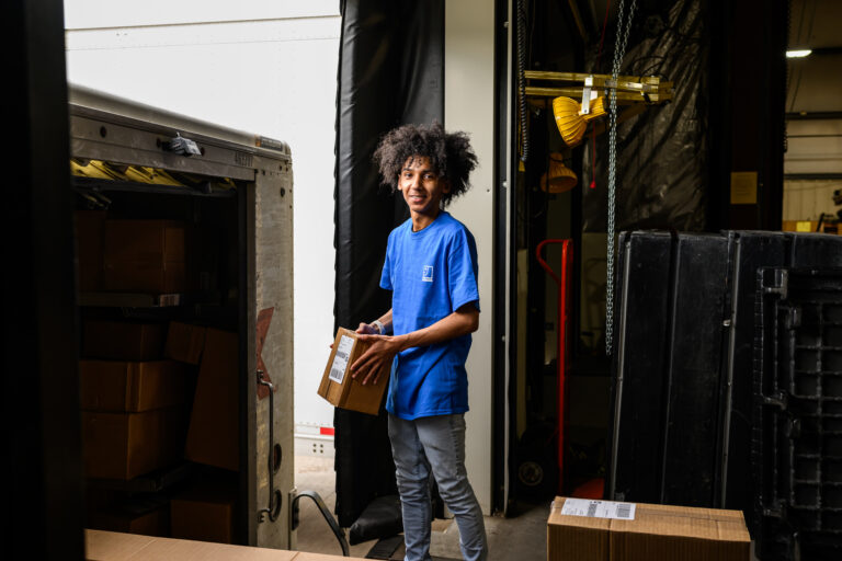 Goodwill employee loading a box in a truck