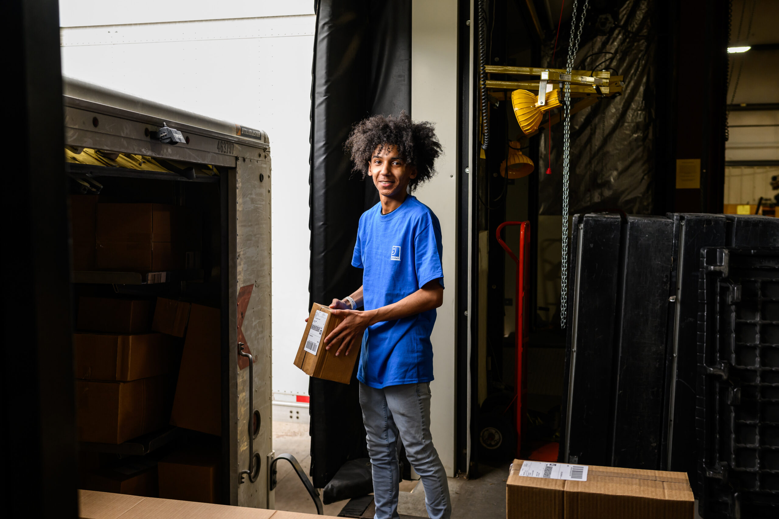 Goodwill employee loading a box in a truck