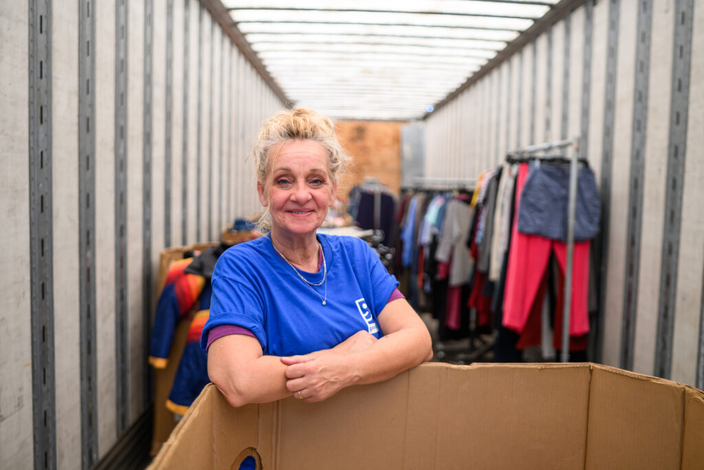 Goodwill employee standing by donations
