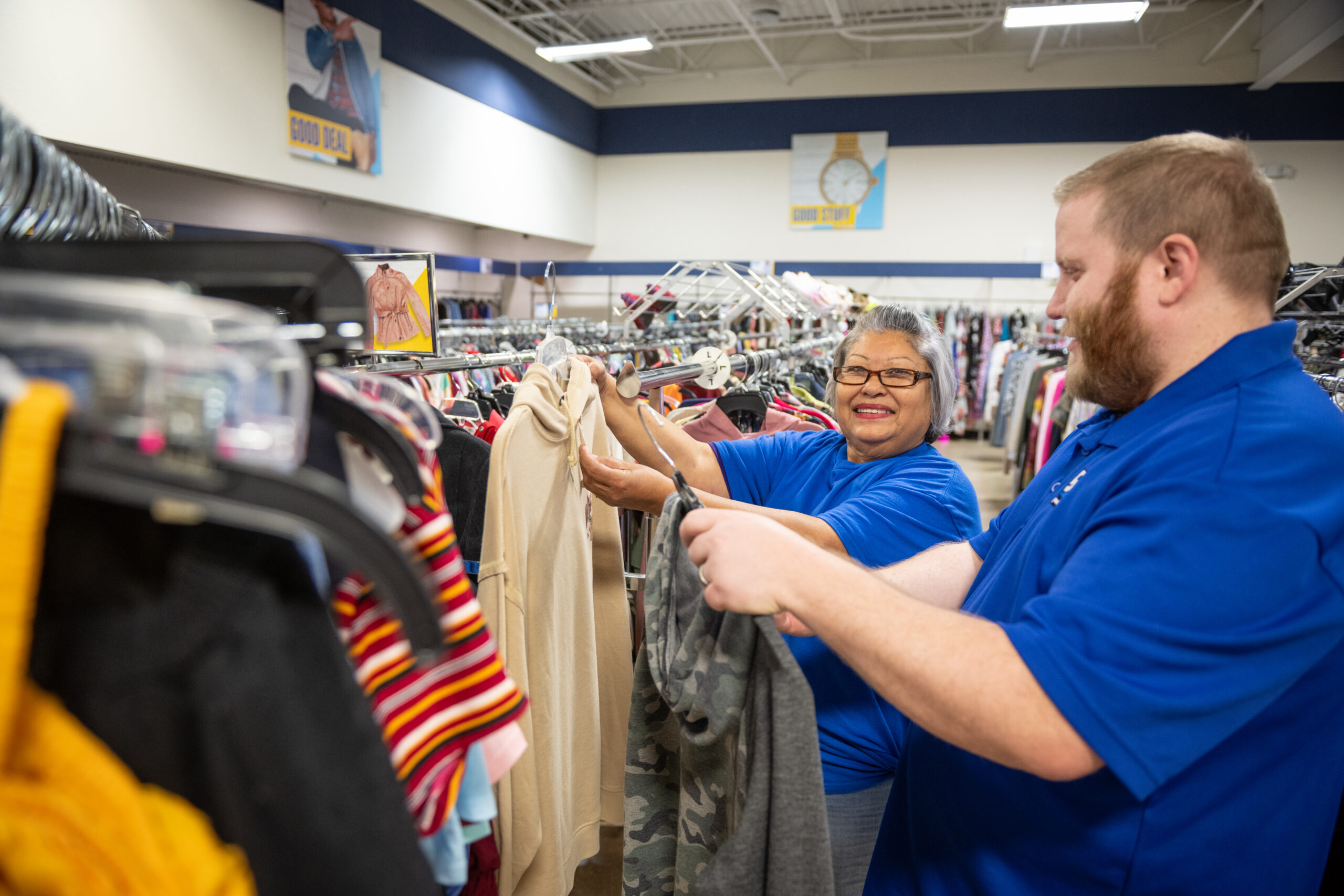 Goodwill employees hanging clothes