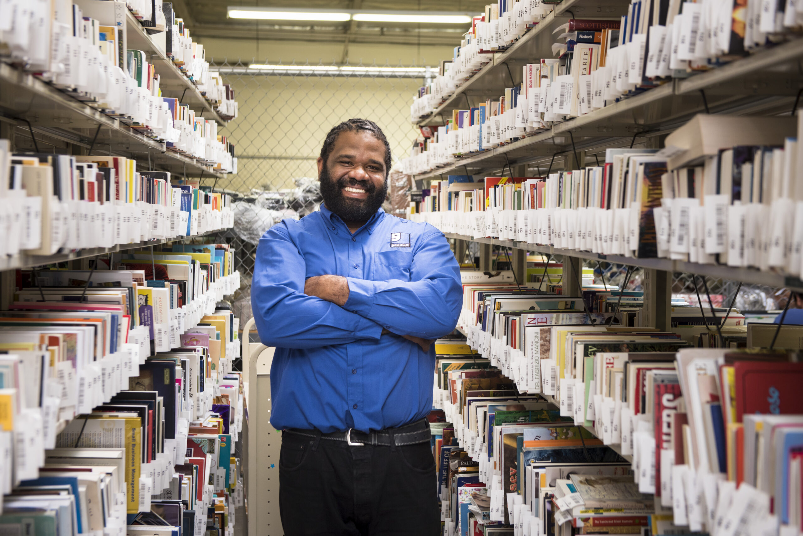 Goodwill employee standing in library